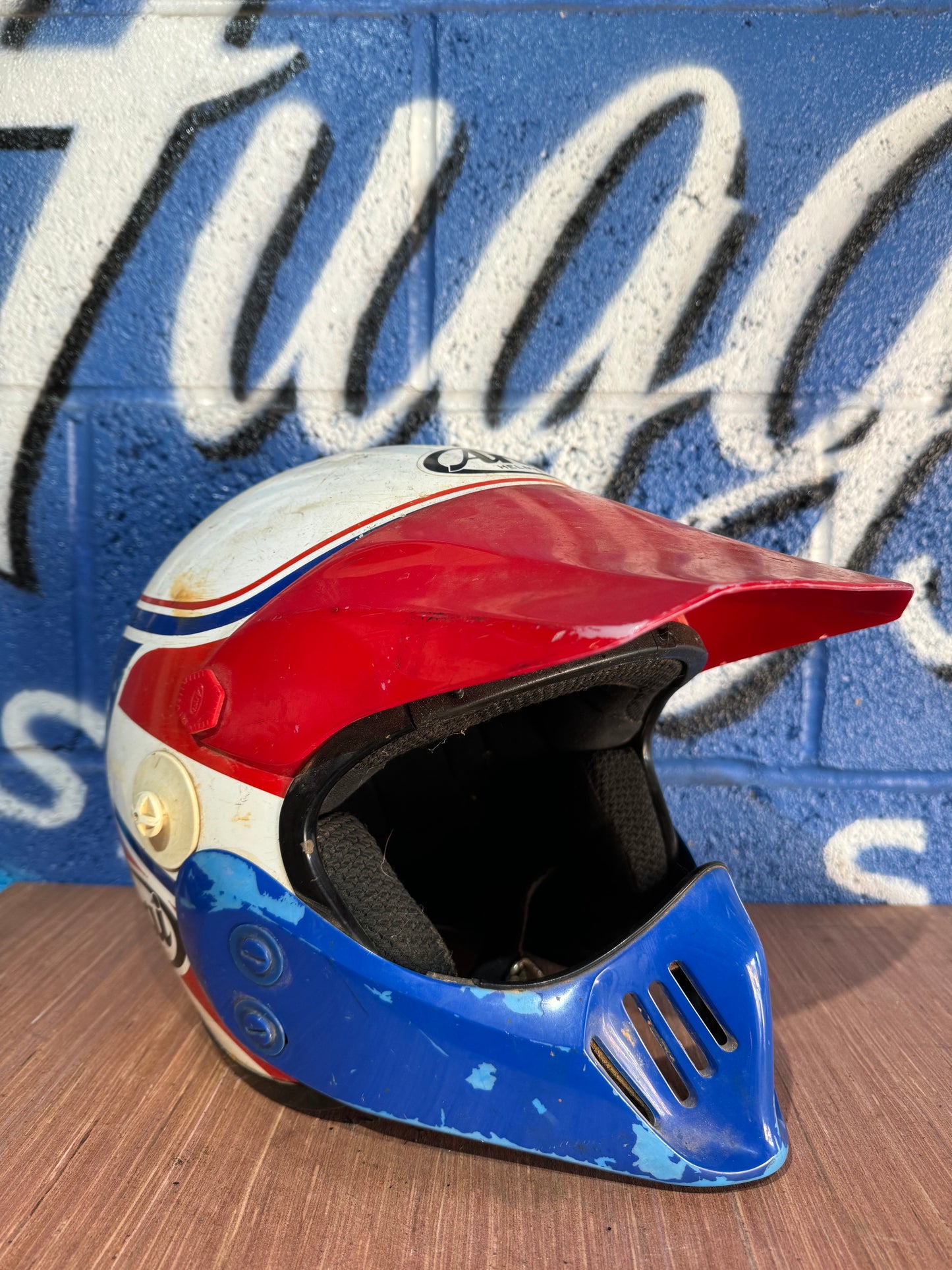 VINTAGE LARGE ARAI RED WHITE AND BLUE MOTOCROSS HELMET